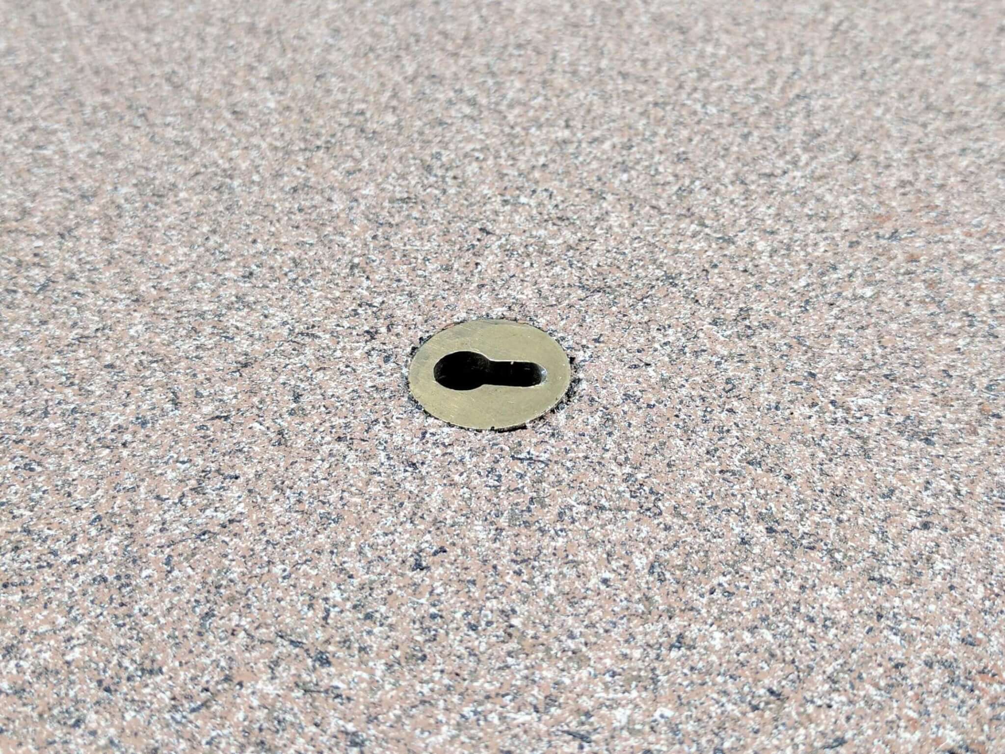Brass Keyhole Anchor installed in a pool deck Brass Keyhole Anchor installed in a pool deck